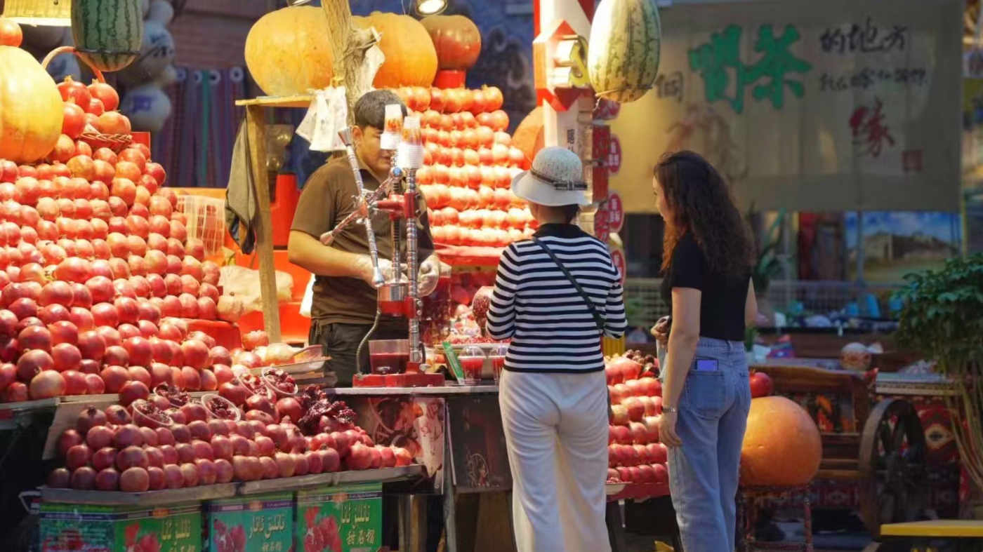 喀什古城內(nèi)游客購買鮮榨石榴汁。人民網(wǎng) 皇甫萬里攝